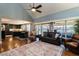 Open-concept living room with hardwood floors and comfortable seating and dining area at 106 Nashua Cv, Louisburg, NC 27549