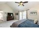 Spacious main bedroom with a vaulted ceiling, ceiling fan, and a private balcony at 106 Nashua Cv, Louisburg, NC 27549