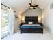 Relaxing main bedroom with ceiling fan and sliding door to a balcony with natural light at 106 Nashua Cv, Louisburg, NC 27549