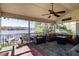 Spacious screened porch with ceiling fan, outdoor furniture, and water view at 106 Nashua Cv, Louisburg, NC 27549