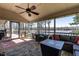 Spacious screened porch with ceiling fan, outdoor furniture, and water view at 106 Nashua Cv, Louisburg, NC 27549