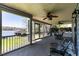 Spacious screened porch with ceiling fans, outdoor furniture, and water view at 106 Nashua Cv, Louisburg, NC 27549
