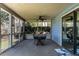 Screened porch features ceiling fan and dining table with beautiful backyard view at 106 Nashua Cv, Louisburg, NC 27549