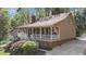 Charming home with a cozy front porch and a well-maintained yard, nestled among trees at 1208 Turner Farms Rd, Garner, NC 27529