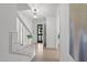 Bright foyer with staircase, light wood floors, modern lighting, and neutral paint at 1208 Turner Farms Rd, Garner, NC 27529