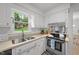 Clean and efficient kitchen with stainless steel appliances and a view of the outdoors at 1208 Turner Farms Rd, Garner, NC 27529