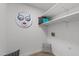 Functional laundry room with open shelving for storage and decorative art on the wall at 1208 Turner Farms Rd, Garner, NC 27529