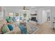 Bright living room featuring a white brick fireplace, ceiling fan, and stylish decor at 1208 Turner Farms Rd, Garner, NC 27529