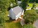 Stunning aerial view of a home with a well-maintained lawn, mature trees, and a paved driveway at 1222 Dixie Trl, Raleigh, NC 27607
