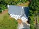 Beautiful aerial view of a two-story home with a manicured lawn, mature trees, private driveway, and a well-maintained roof at 1222 Dixie Trl, Raleigh, NC 27607