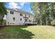 Backyard featuring a well-maintained lawn, wooden deck, and a lush, green landscape at 1222 Dixie Trl, Raleigh, NC 27607