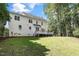 Expansive backyard featuring a deck, lush lawn, and mature trees, ideal for outdoor living and entertaining at 1222 Dixie Trl, Raleigh, NC 27607