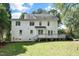 Spacious backyard featuring a deck, lush lawn, mature trees and ample space for outdoor activities and relaxation at 1222 Dixie Trl, Raleigh, NC 27607