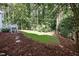 Lush backyard with a wooden deck and a grassy lawn, perfect for outdoor enjoyment at 1222 Dixie Trl, Raleigh, NC 27607