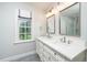 Elegant bathroom featuring double vanity with marble countertop, and a bright window at 1222 Dixie Trl, Raleigh, NC 27607