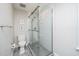 Modern bathroom features a glass shower with white subway tile and gray tile floors at 1222 Dixie Trl, Raleigh, NC 27607
