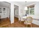 Bright breakfast nook featuring hardwood floors, a bay window with bench seating, and stylish light fixture at 1222 Dixie Trl, Raleigh, NC 27607