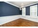 Dining room with blue walls, hardwood floors, white trim and shutters at 1222 Dixie Trl, Raleigh, NC 27607