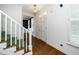Welcoming entryway with hardwood floors, staircase, and entry door at 1222 Dixie Trl, Raleigh, NC 27607