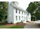 Charming two-story white home with manicured landscaping and circular driveway at 1222 Dixie Trl, Raleigh, NC 27607