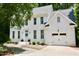 Charming two-story brick home with a light-colored roof, manicured landscaping, and an attached two-car garage at 1222 Dixie Trl, Raleigh, NC 27607