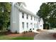 Charming two-story white brick home with a manicured lawn and attached garage at 1222 Dixie Trl, Raleigh, NC 27607