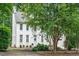 White brick home with tidy landscaping, a driveway, and mature trees at 1222 Dixie Trl, Raleigh, NC 27607