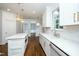 Open kitchen with white cabinets, marble countertops, and stainless steel appliances at 1222 Dixie Trl, Raleigh, NC 27607