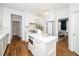 Bright kitchen features white cabinets, stainless appliances, and an island with gold pendant lighting at 1222 Dixie Trl, Raleigh, NC 27607