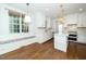 Modern kitchen with an eat-in nook, white cabinetry, and hardwood floors at 1222 Dixie Trl, Raleigh, NC 27607