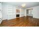 Bright living room with custom built-ins, fireplace, and hardwood floors at 1222 Dixie Trl, Raleigh, NC 27607