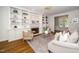 Cozy living room with a fireplace, built-in bookshelves, hardwood floors, and neutral-toned furnishings at 1222 Dixie Trl, Raleigh, NC 27607