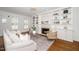 Bright living room with fireplace, built-in shelving, hardwood floors, neutral furniture and natural light at 1222 Dixie Trl, Raleigh, NC 27607