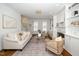 Bright living room with fireplace, built-in shelving, hardwood floors, neutral furniture and large windows at 1222 Dixie Trl, Raleigh, NC 27607