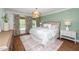 Inviting bedroom with soft green walls, floral curtains, and a comfortable king bed at 1222 Dixie Trl, Raleigh, NC 27607