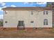 Exterior view of the back of the house showing the siding, patio and stairs, and the dual air conditioning units at 125 Vance Wrenn Rd, Roxboro, NC 27573