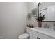 Bathroom featuring a decorative mirror, vanity sink, and toilet at 125 Vance Wrenn Rd, Roxboro, NC 27573