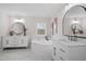 Bathroom featuring a white bathtub, marble flooring, and two vanity sinks at 125 Vance Wrenn Rd, Roxboro, NC 27573