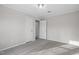 Bedroom featuring neutral walls, carpet, trim, a closet, and access to other rooms at 125 Vance Wrenn Rd, Roxboro, NC 27573