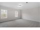 Bedroom featuring neutral walls, carpet, trim, and two windows that let in natural light at 125 Vance Wrenn Rd, Roxboro, NC 27573
