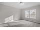 Bedroom featuring neutral walls, carpet, trim, and two windows that let in natural light at 125 Vance Wrenn Rd, Roxboro, NC 27573