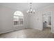 Dining area with a modern chandelier, a large window, and light-colored wood flooring at 125 Vance Wrenn Rd, Roxboro, NC 27573