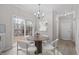 Bright breakfast nook with modern chandelier and view of the backyard through sliding glass doors at 125 Vance Wrenn Rd, Roxboro, NC 27573