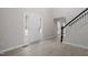 Bright entryway features wood-look floors, front door with sidelights and staircase with black banister at 125 Vance Wrenn Rd, Roxboro, NC 27573