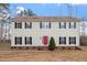 Traditional two-story home with a red front door, black shutters and symmetrical windows at 125 Vance Wrenn Rd, Roxboro, NC 27573
