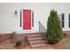 Well-maintained brick front steps lead up to the charming bright red front door, with black iron railing at 125 Vance Wrenn Rd, Roxboro, NC 27573