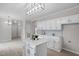 Open kitchen with island, sleek cabinetry, and modern lighting fixtures at 125 Vance Wrenn Rd, Roxboro, NC 27573