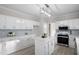 Bright kitchen featuring white cabinets, stainless steel appliances, and a stylish island at 125 Vance Wrenn Rd, Roxboro, NC 27573
