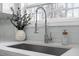 Close up of a stainless steel faucet and kitchen sink with a bright window at 125 Vance Wrenn Rd, Roxboro, NC 27573