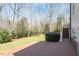 Expansive backyard featuring a spacious deck, lush greenery, and mature trees at 1412 Wynncrest Ct, Raleigh, NC 27603